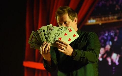 Magician with large cards for a trick